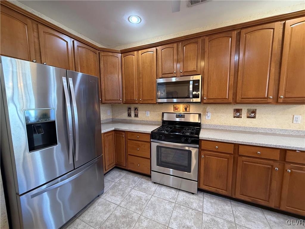 1847 Gregory Place Hellertown, PA 18055 - Photo 7 of 27 a kitchen with granite countertop stainless steel appliances and wooden cabinets