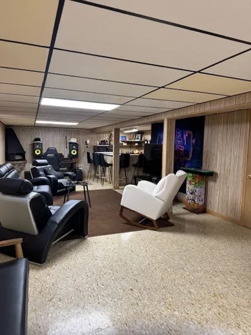 a living room with furniture and a ceiling fan