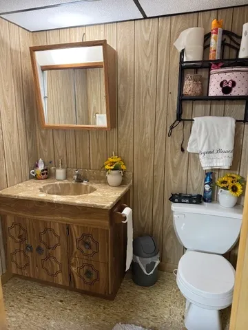 a bathroom with a toilet sink and mirror