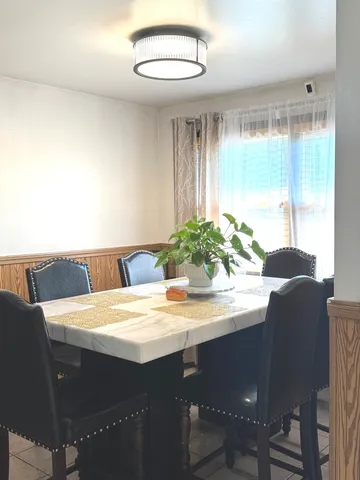 a dining room with furniture and window