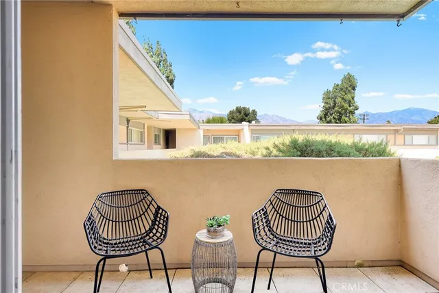 a view of a balcony with chair and table