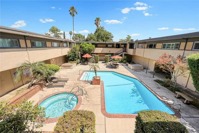 a view of a swimming pool and outdoor seating