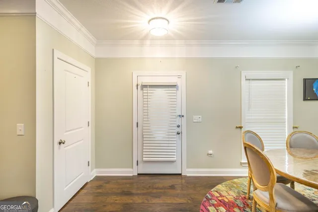 a view of a hallway with wooden floor and chair