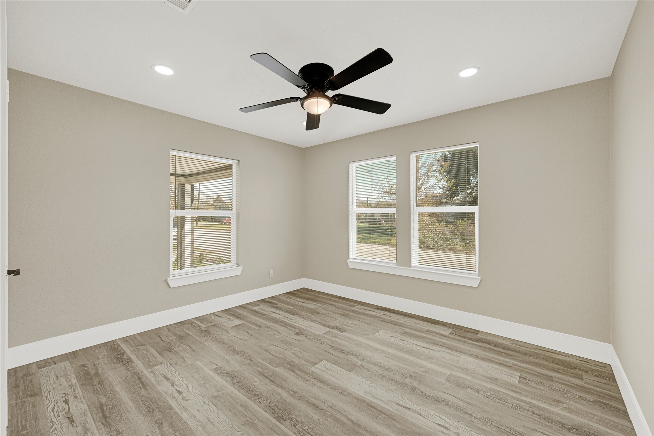3510 Nagle Street Houston, TX 77004 - Photo 14 of 26 a view of an empty room with a window and wooden floor