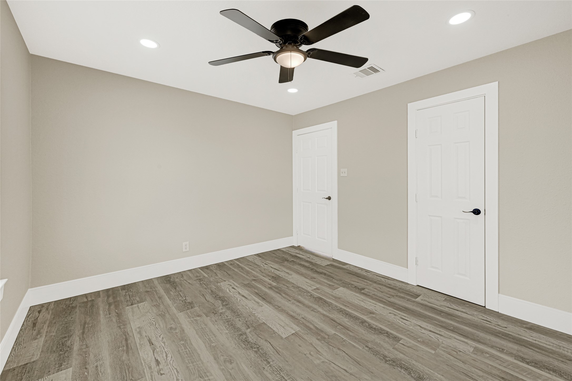 3510 Nagle Street Houston, TX 77004 - Photo 15 of 26 a view of a room with wooden floor and a ceiling fan