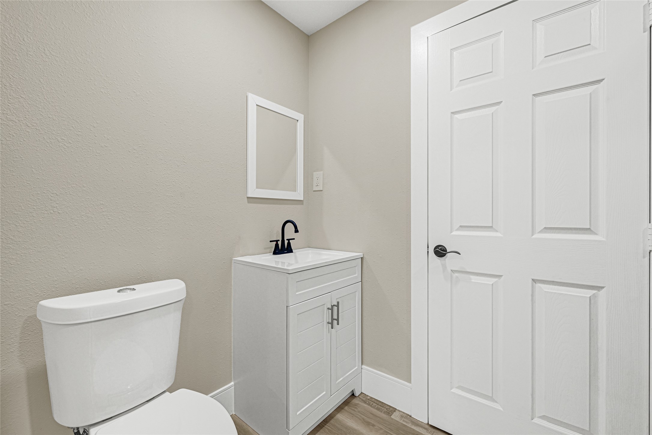 3510 Nagle Street Houston, TX 77004 - Photo 22 of 26 a white toilet sitting next to a bathroom sink