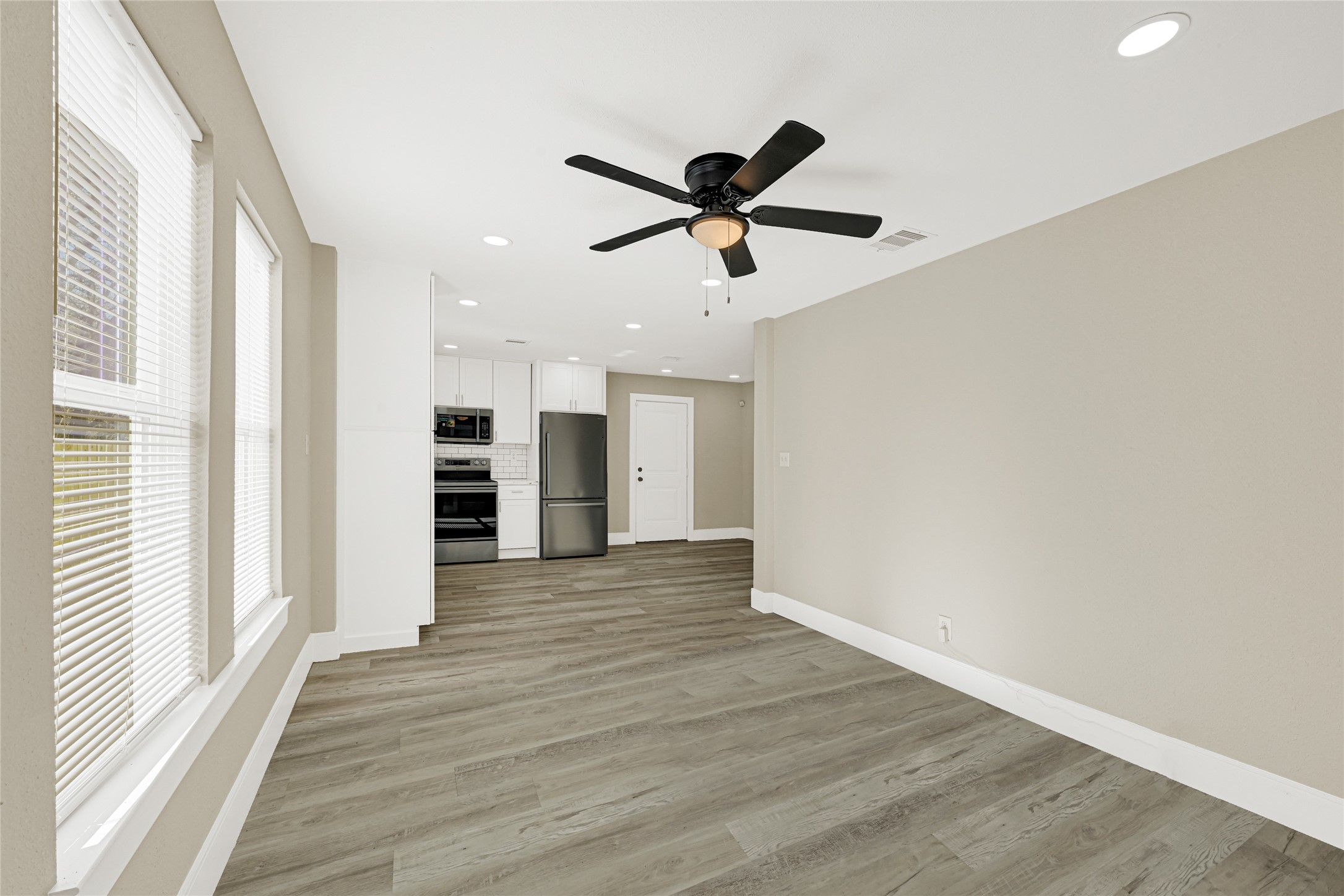 3510 Nagle Street Houston, TX 77004 - Photo 5 of 26 a view of a big room with wooden floor and windows