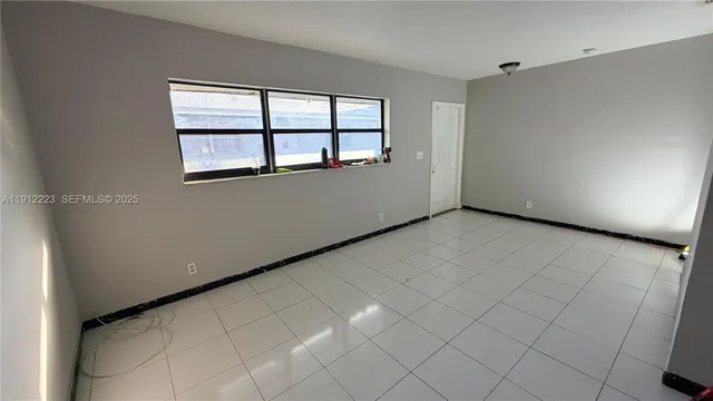 a view of an empty room with a window