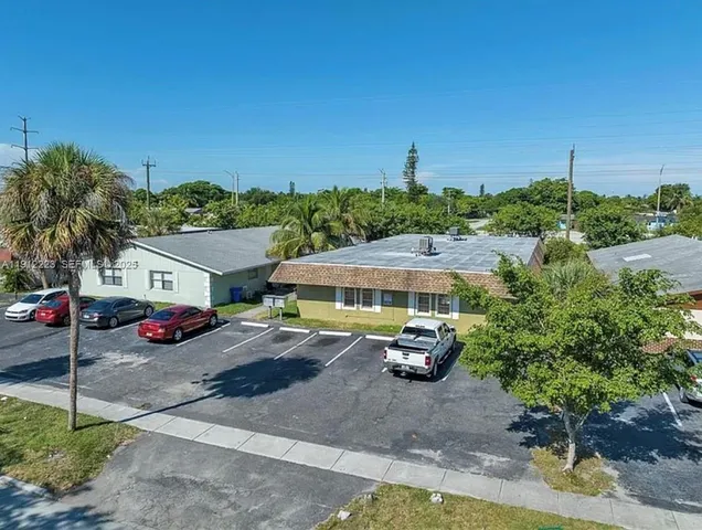 a front view of a house with cars parked