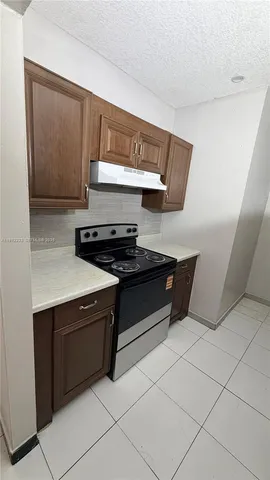 a kitchen with stainless steel appliances granite countertop a sink and a stove