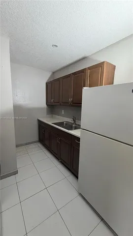 a kitchen with a cabinets and white appliances