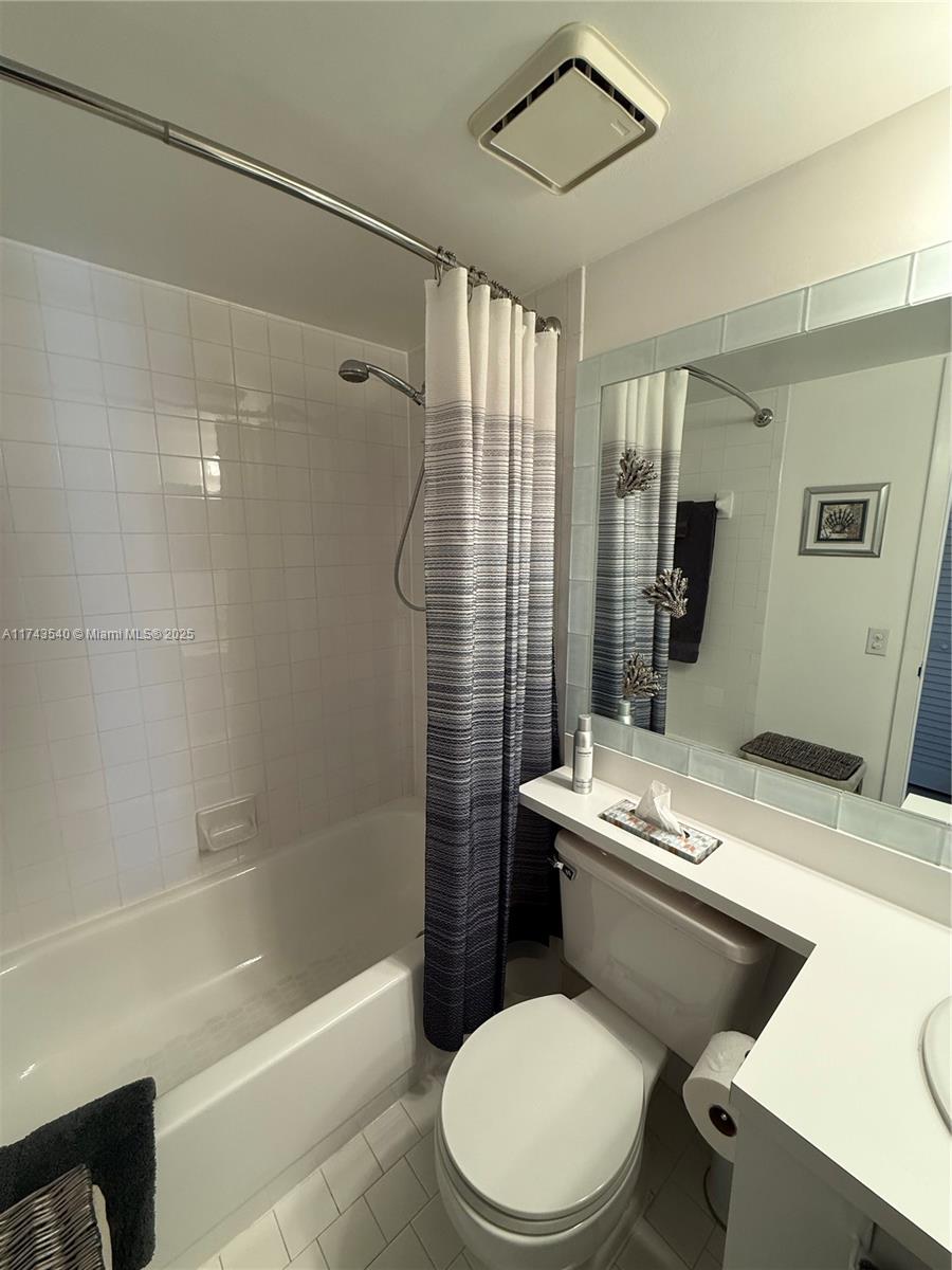 609 Waterside Drive, Unit 609 Hypoluxo, FL 33462 - Photo 17 of 33 a white toilet sitting next to a bath tub shower