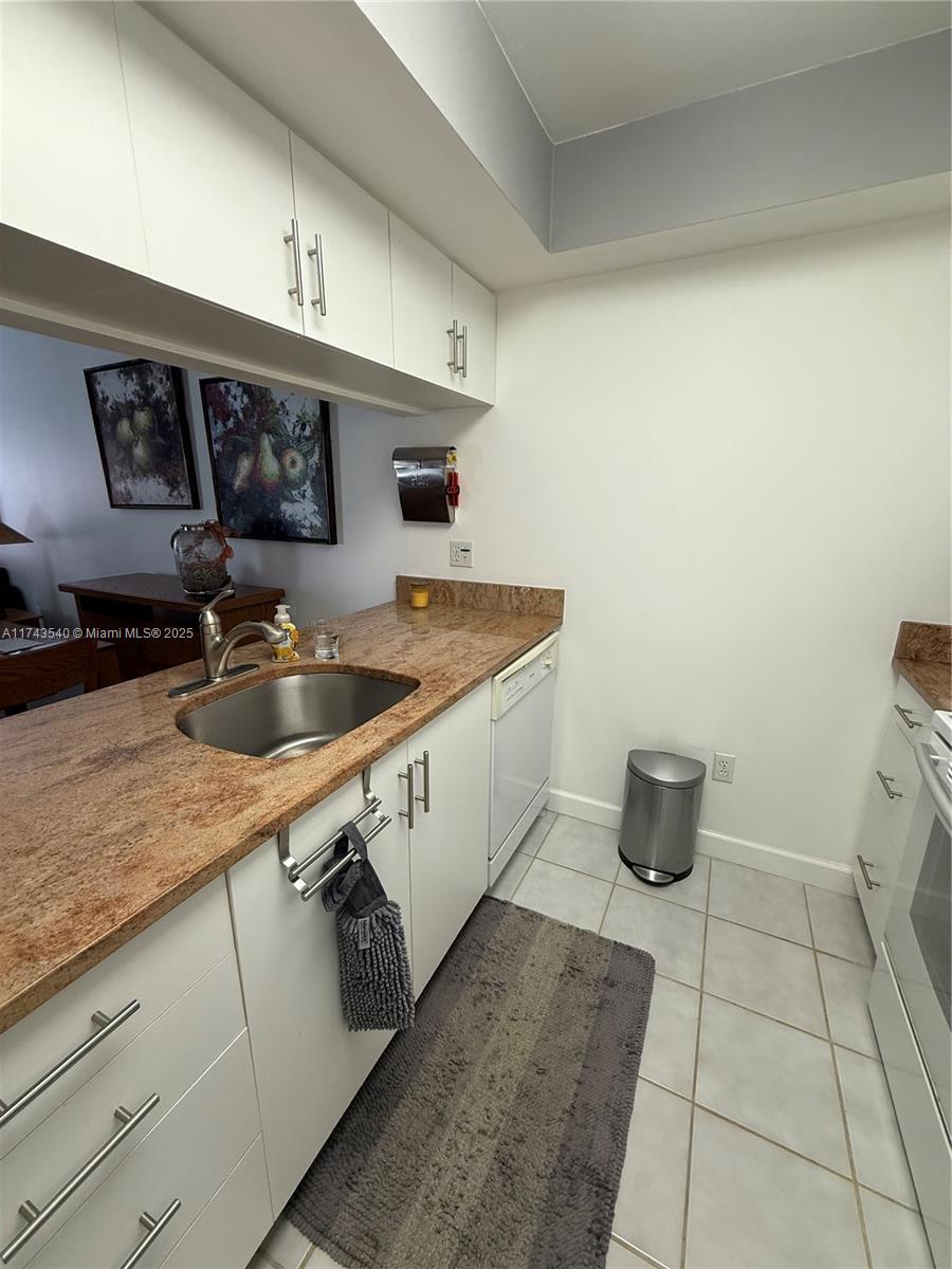 609 Waterside Drive, Unit 609 Hypoluxo, FL 33462 - Photo 22 of 33 a kitchen with a sink and cabinets