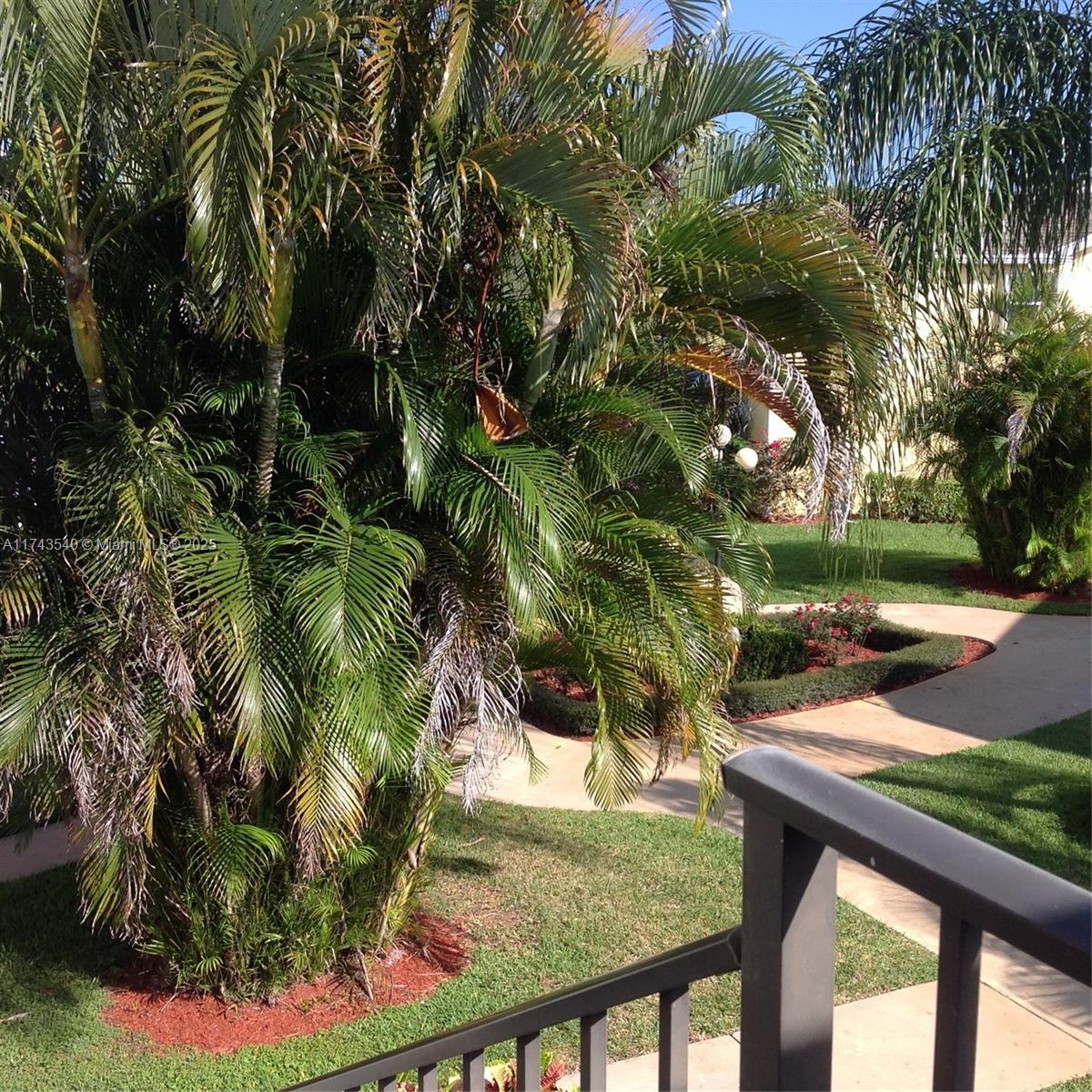 609 Waterside Drive, Unit 609 Hypoluxo, FL 33462 - Photo 31 of 33 a view of backyard with plants and outdoor seating