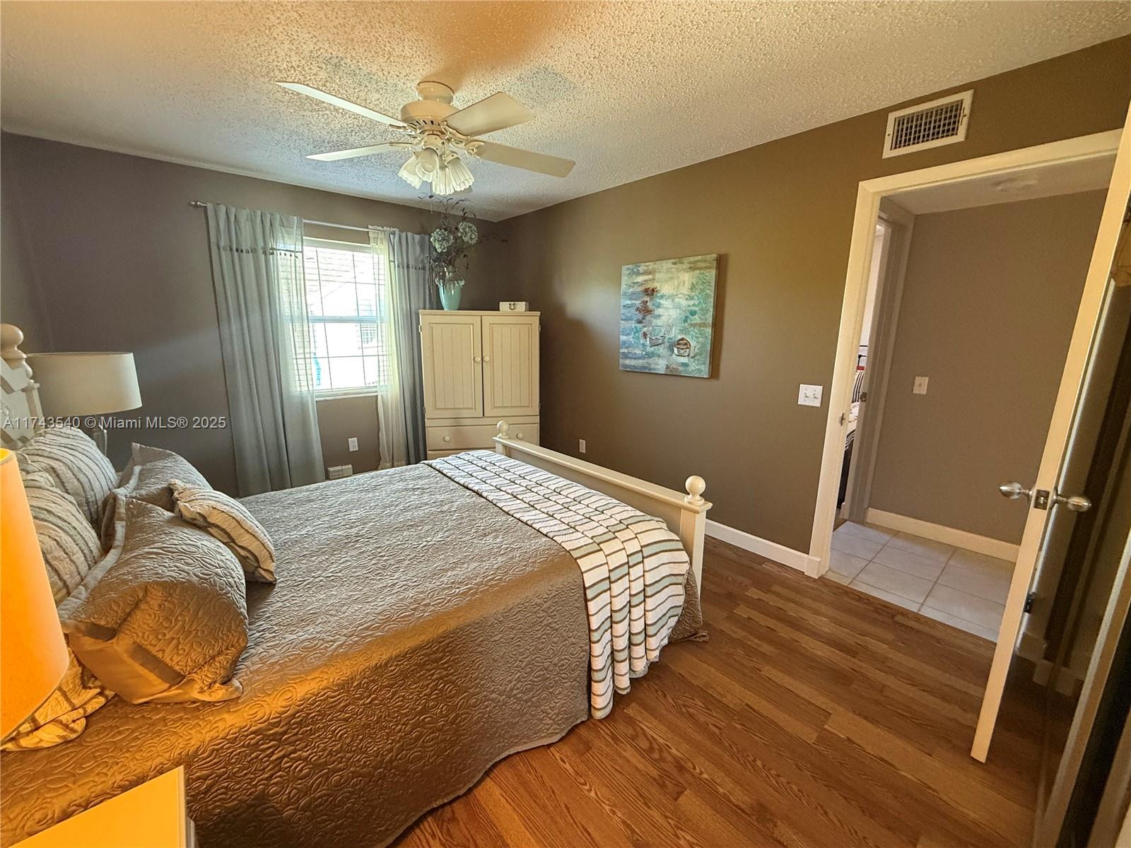 609 Waterside Drive, Unit 609 Hypoluxo, FL 33462 - Photo 10 of 33 a bedroom with a bed and window