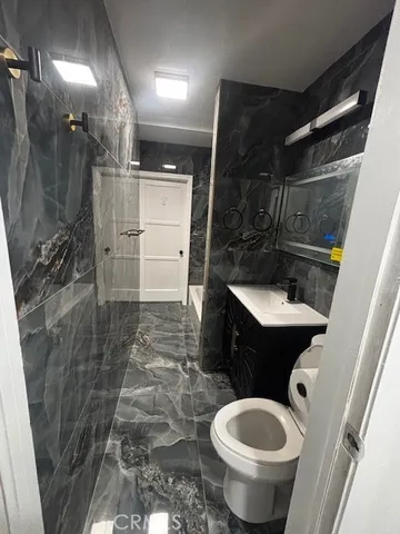 a bathroom with a toilet and a shower