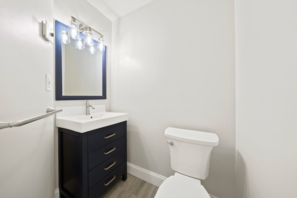 70 Burdean Road Newton, MA 02459 - Photo 21 of 38 a bathroom with a toilet a sink and mirror