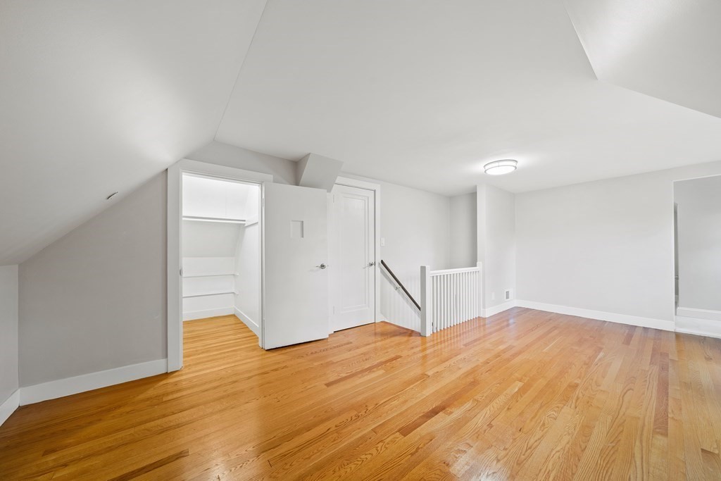 70 Burdean Road Newton, MA 02459 - Photo 29 of 38 a bedroom with a bed and wooden floor