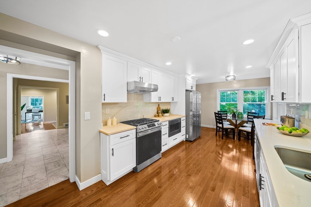 70 Burdean Road Newton, MA 02459 - Photo 8 of 38 a kitchen with a table chairs stove and cabinets