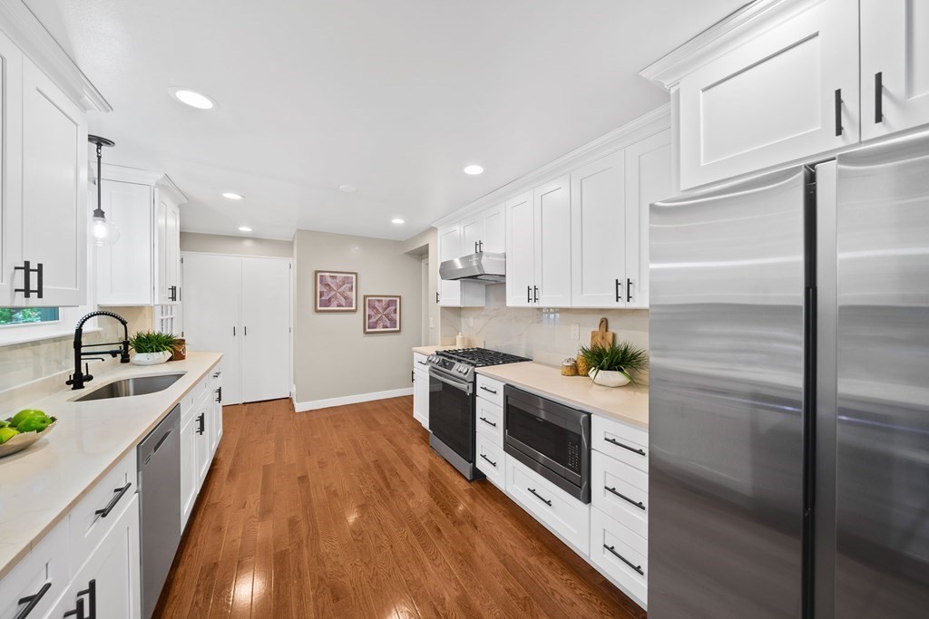 70 Burdean Road Newton, MA 02459 - Photo 10 of 38 a kitchen with stainless steel appliances granite countertop a stove top oven a sink and a refrigerator