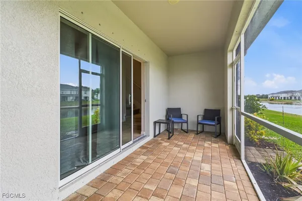 a porch with a table and chairs