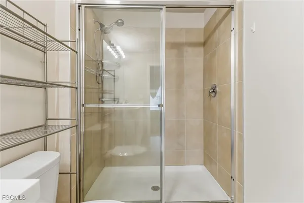 a bathroom with a shower and a glass door