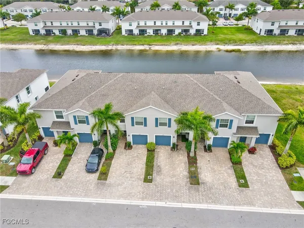 an aerial view of a house with outdoor space and lake view