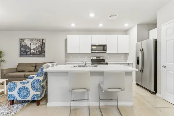 a kitchen with stainless steel appliances a refrigerator and a stove top oven