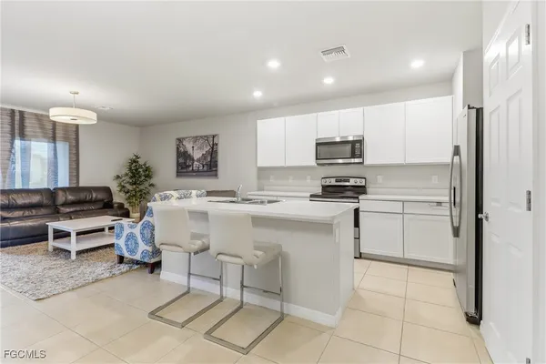 a kitchen with a sink cabinets and stainless steel appliances