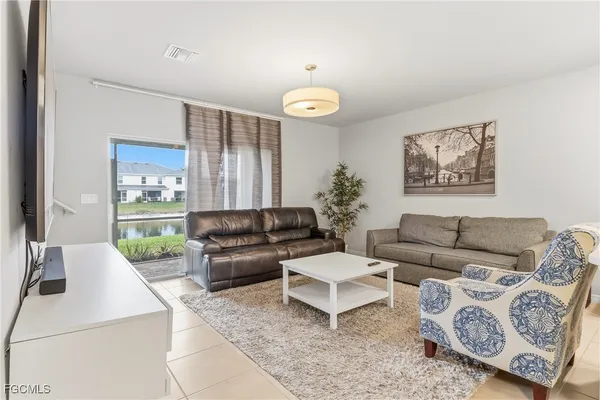 a living room with furniture and a large window