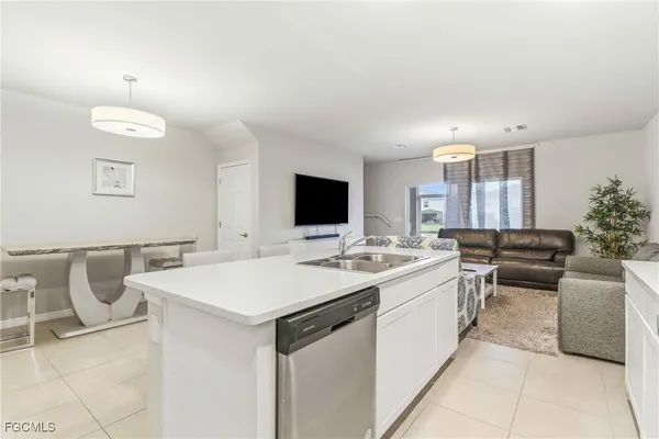 a kitchen with a stove a sink and a refrigerator