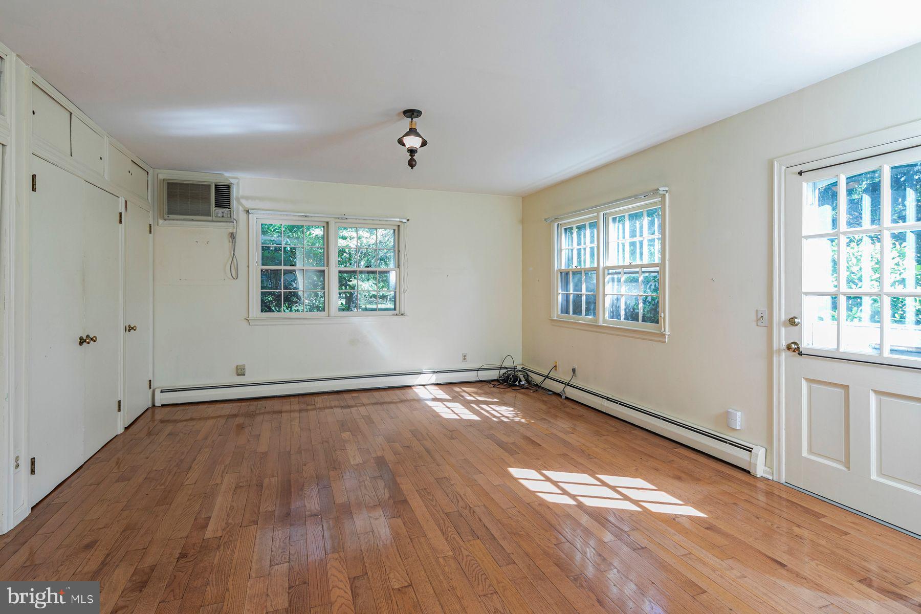 158 Carter Road Princeton, NJ 08540 - Photo 17 of 29 an empty room with wooden floor and windows