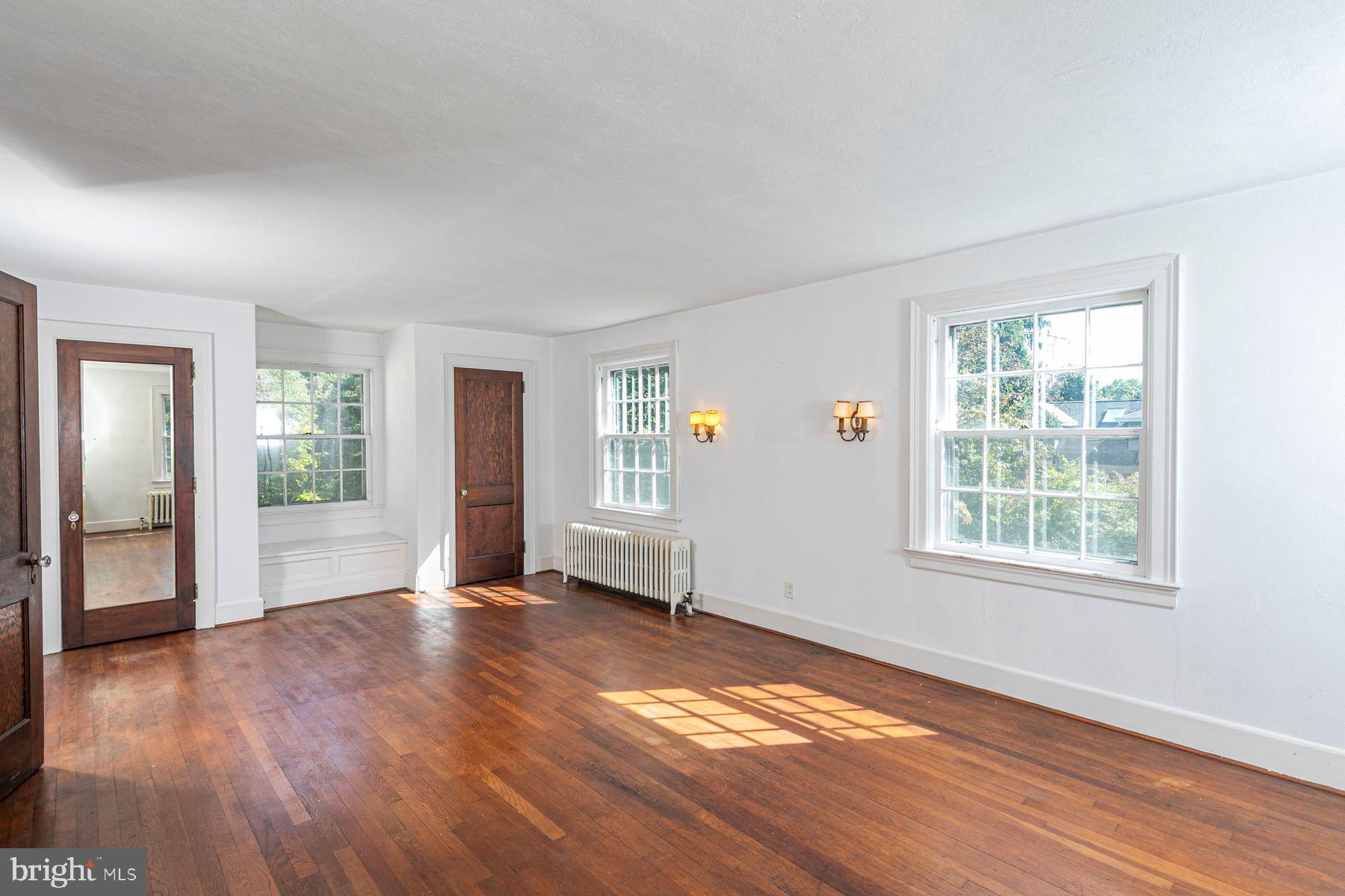 158 Carter Road Princeton, NJ 08540 - Photo 20 of 29 an empty room with wooden floor and windows