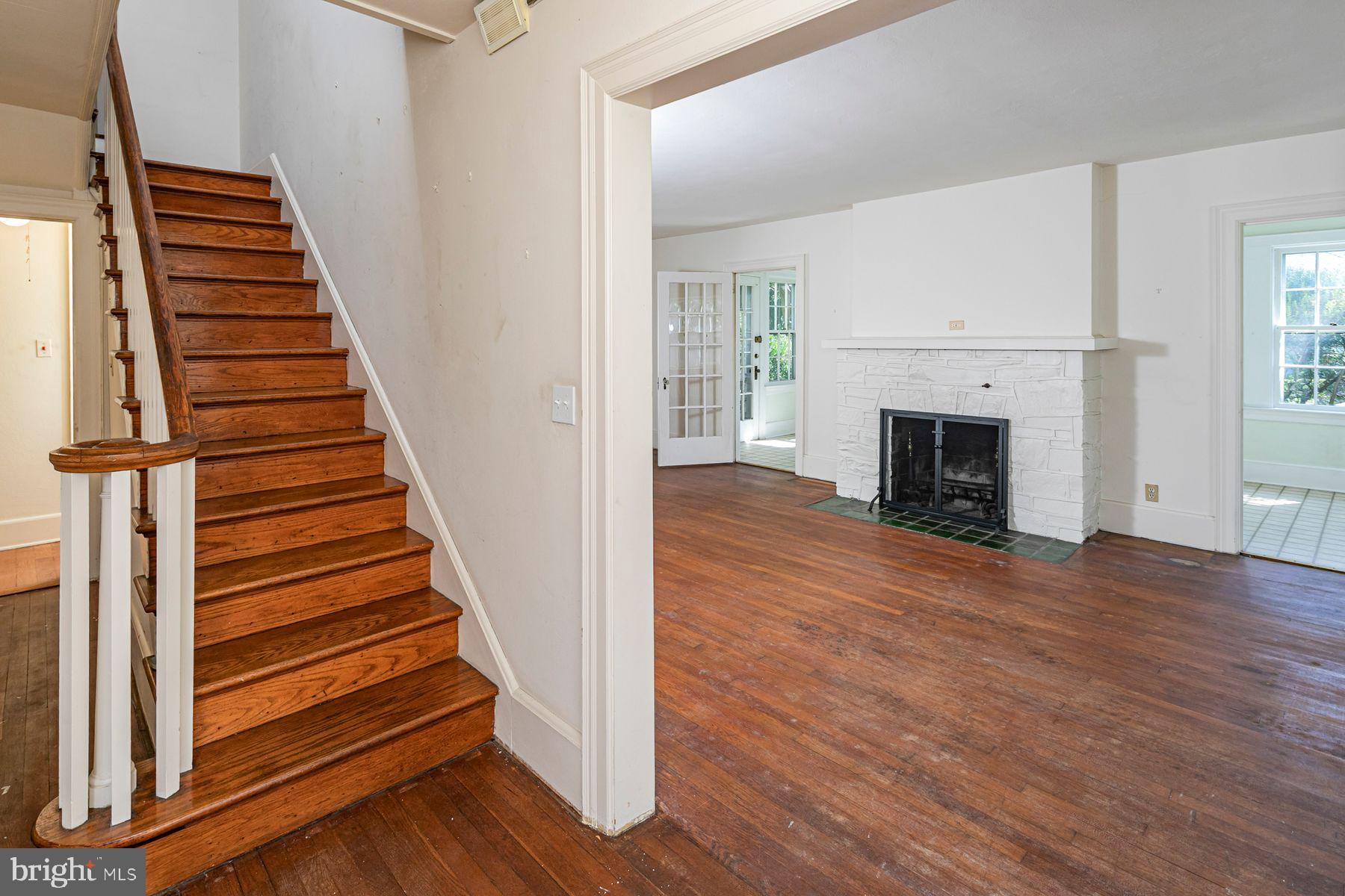 158 Carter Road Princeton, NJ 08540 - Photo 5 of 29 an entryway in a hall with wooden floor and a fireplace