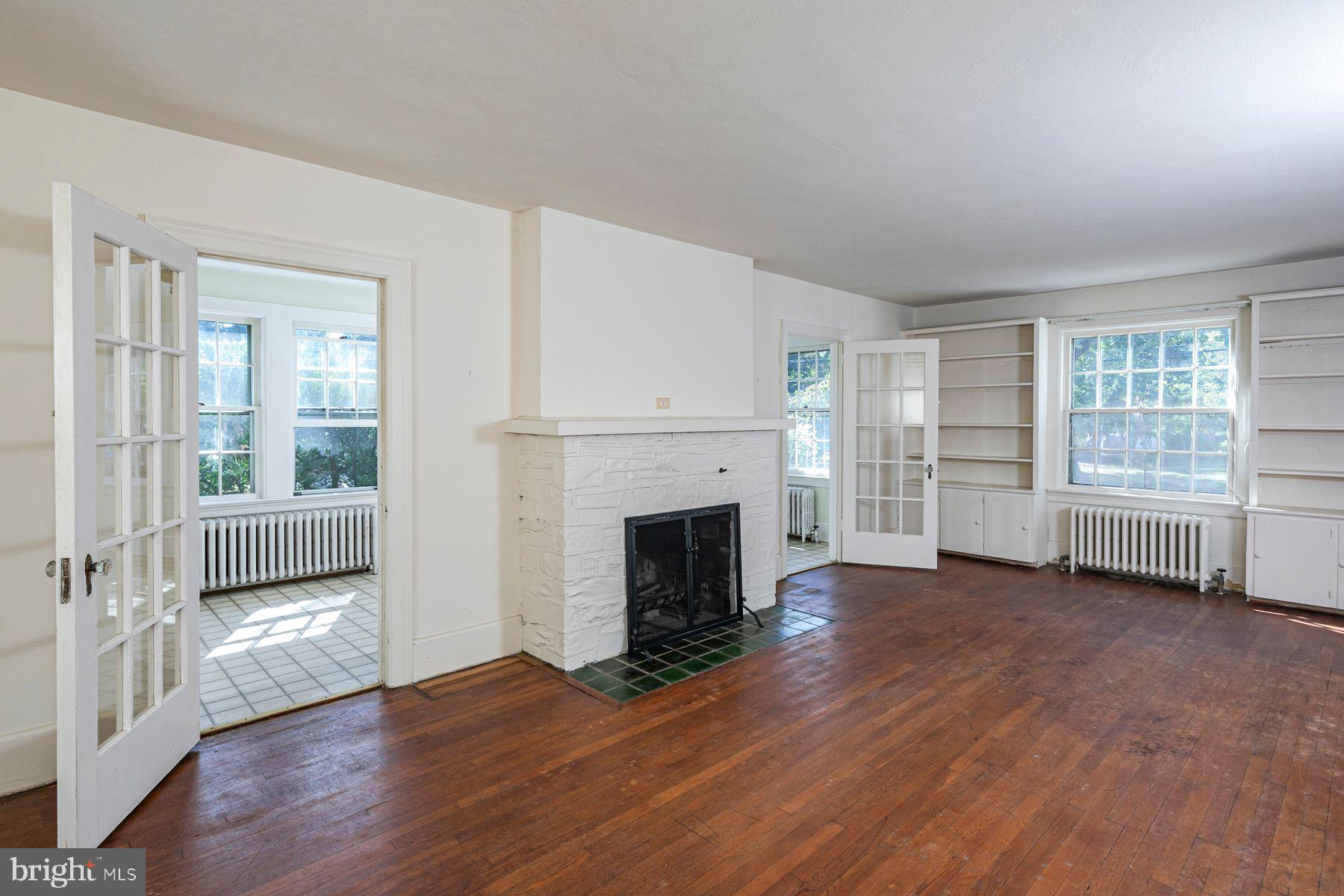 158 Carter Road Princeton, NJ 08540 - Photo 8 of 29 wooden floor fireplace and windows in an empty room