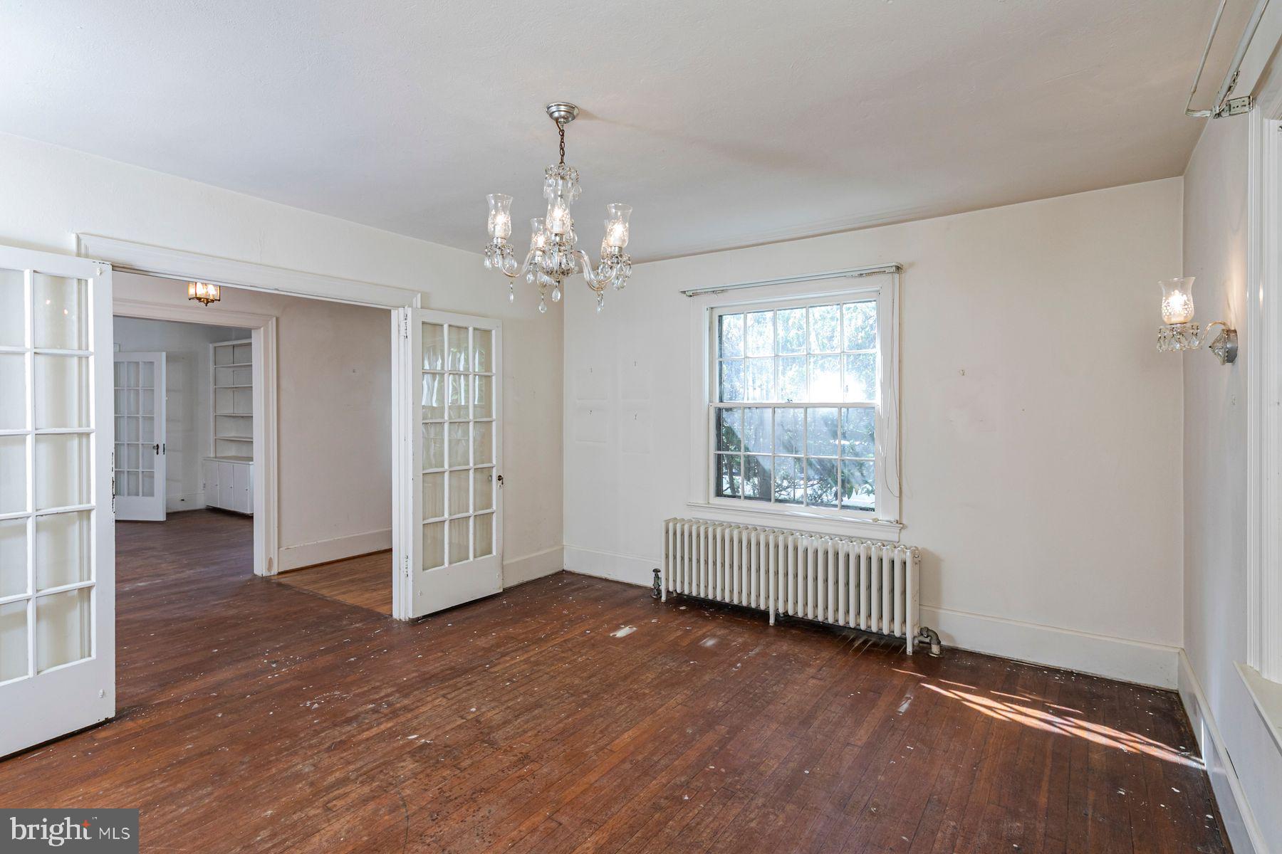 158 Carter Road Princeton, NJ 08540 - Photo 10 of 29 an empty room with wooden floor chandelier and windows