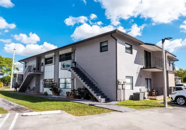 a view of a house with swimming pool and sitting area