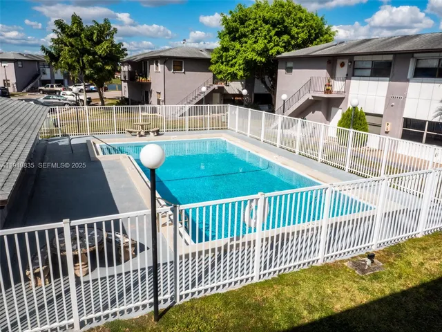 a view of a patio with couches table and chairs and potted plants