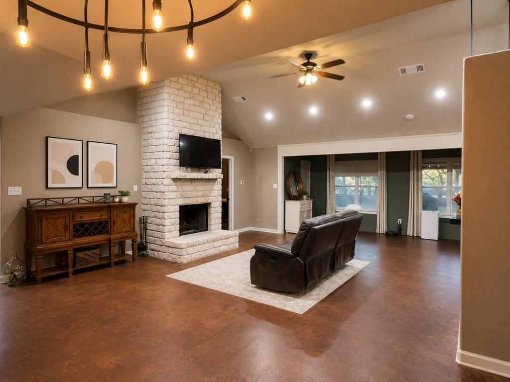 420 Sessums Road Springtown, TX 76082 - Photo 5 of 40 Spacious living area featuring a vaulted ceiling, recessed lighting, and rich wood-finish flooring-virtually staged