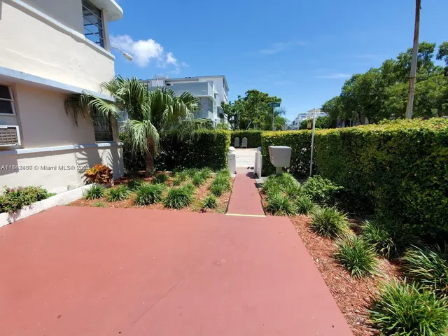 a view of house with backyard and sitting area