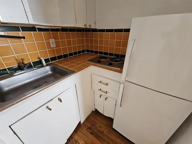 a bathroom with a sink mirror toilet and bathtub