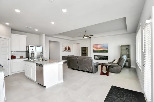 a living room with furniture and a kitchen
