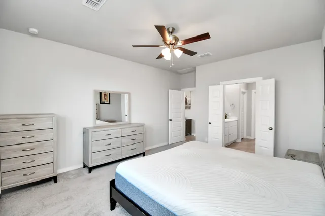 a bedroom with a bed and a dresser