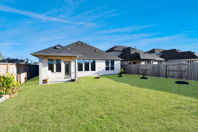 a front view of a house with a yard table and chairs