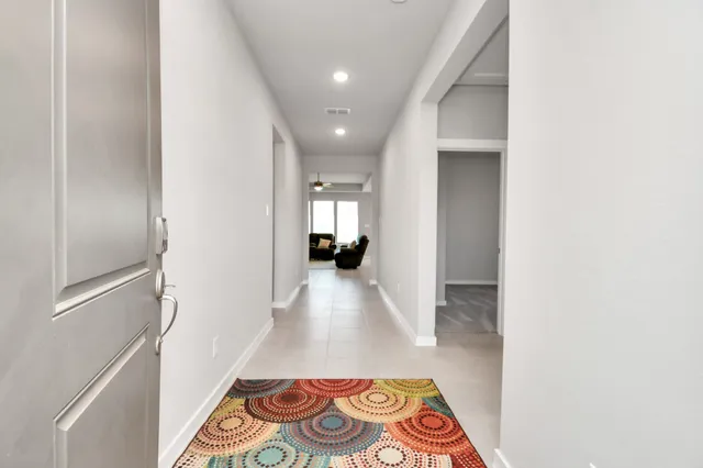a view of hallway with wooden floor