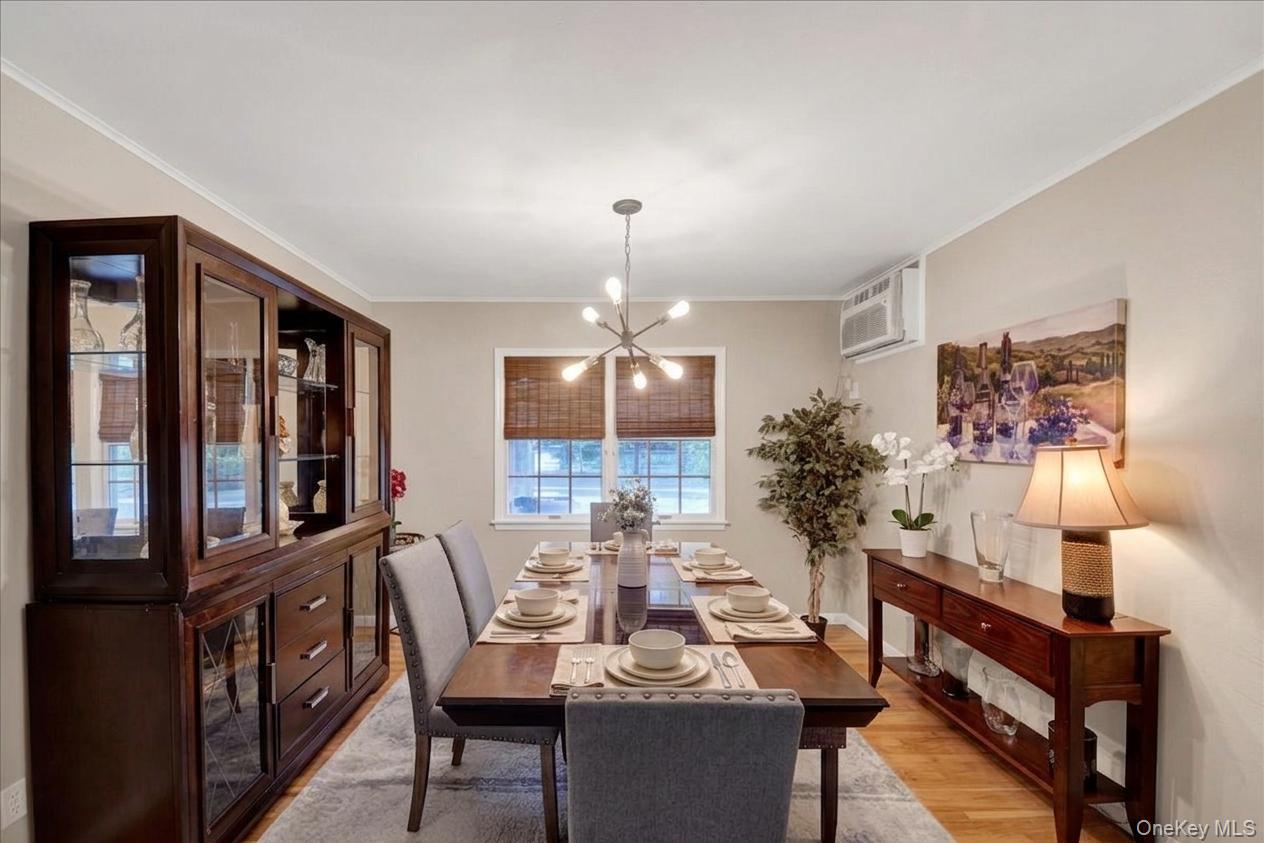 10 Susquehanna Road Ossining, NY 10562 - Photo 6 of 31 Dining area featuring wood-finish flooring, neutral wall tones, and a modern sputnik chandelier