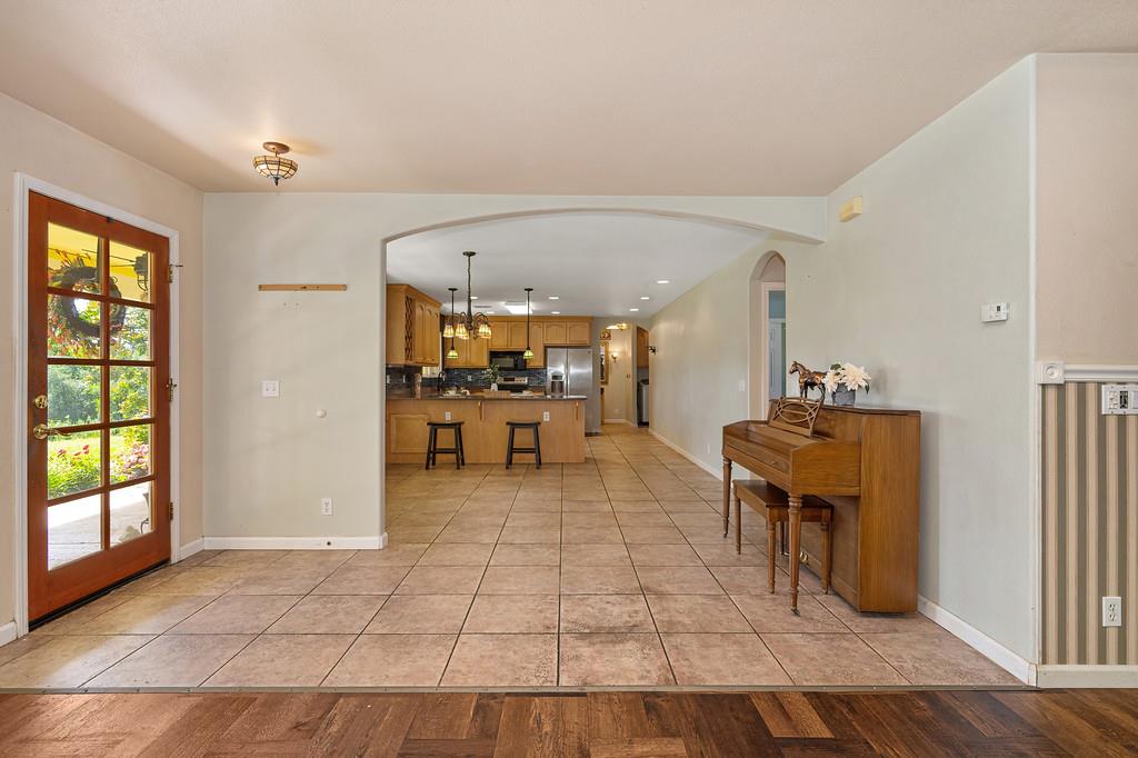 6181 Lambert Lane El Dorado, CA 95623 - Photo 16 of 68 foyer entrance with light tile patterned floors, arched walkways, and recessed lighting