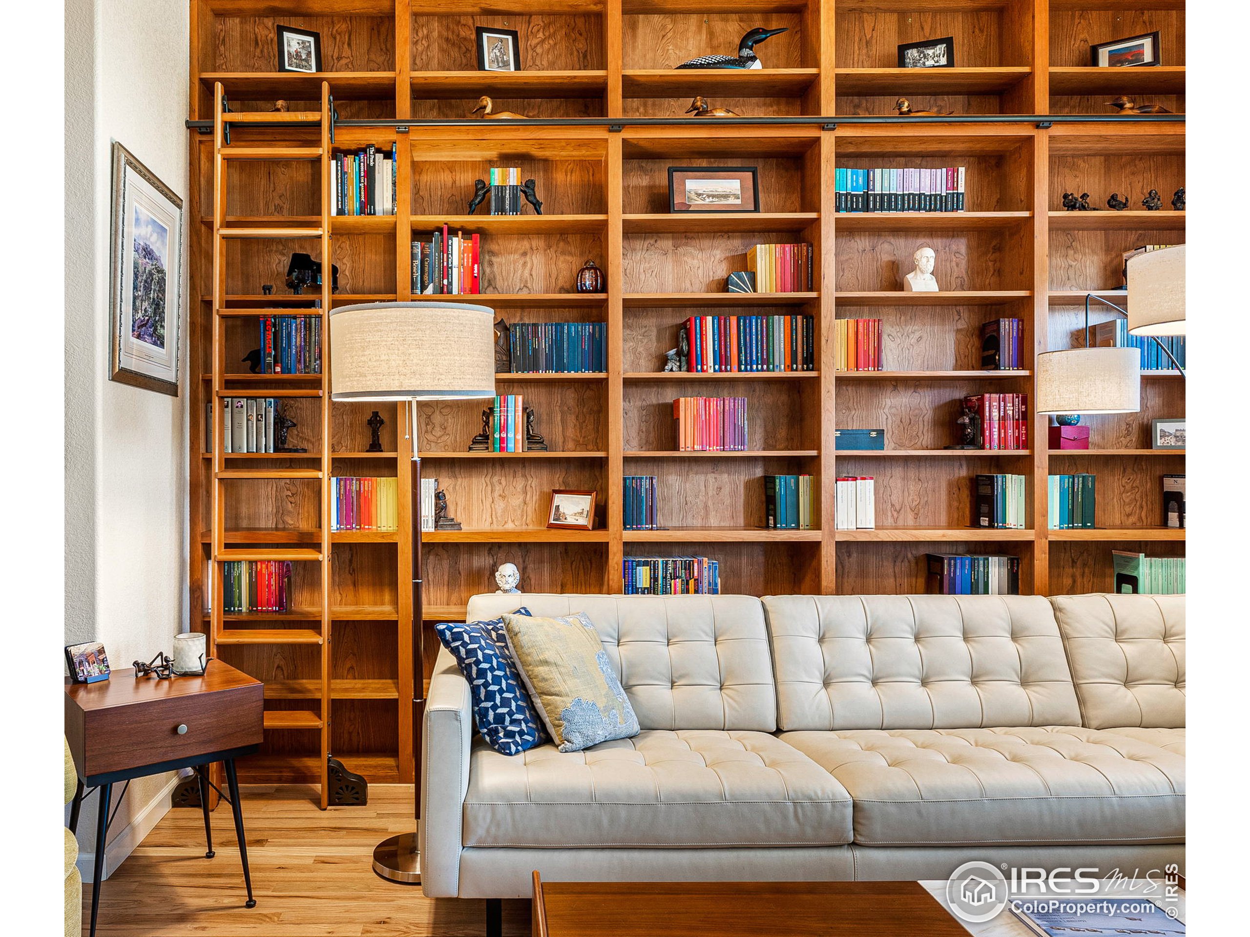 a living room with furniture and a book shelf