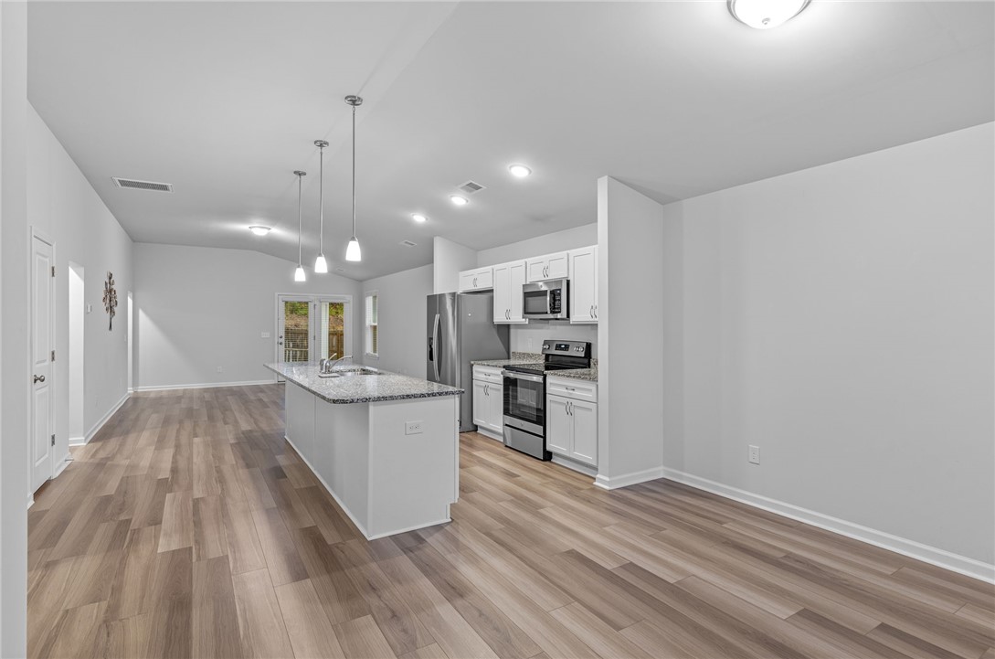 24 Chalet Court Anderson, SC 29621 - Photo 6 of 39 This bright kitchen with a spacious island connects seamlessly to the open living area.