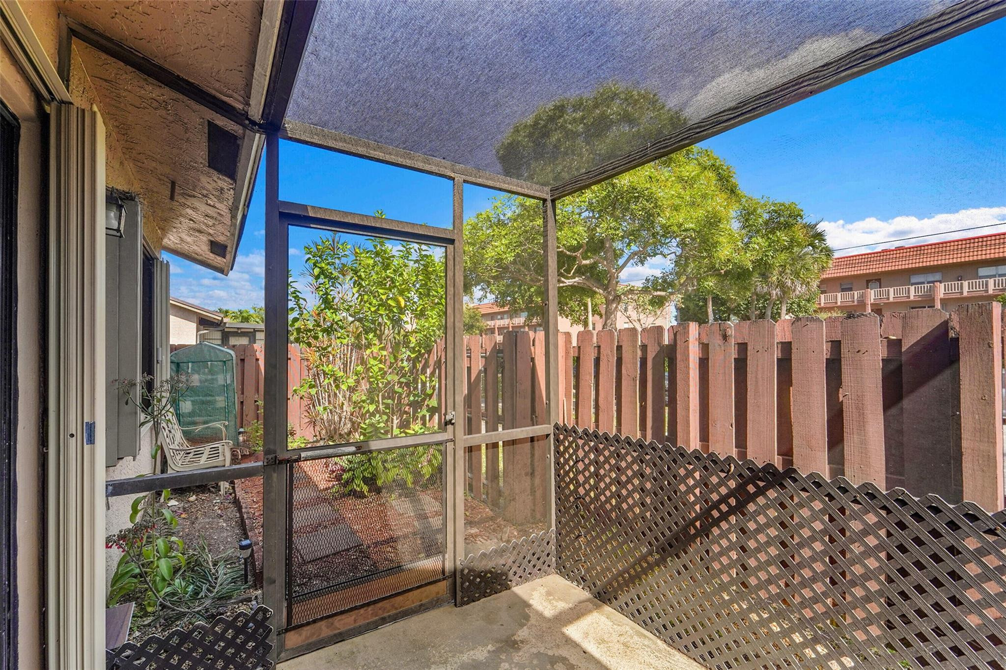 2698 North Nob Hill Road Sunrise, FL 33322 - Photo 21 of 27 a view of a backyard with wooden fence